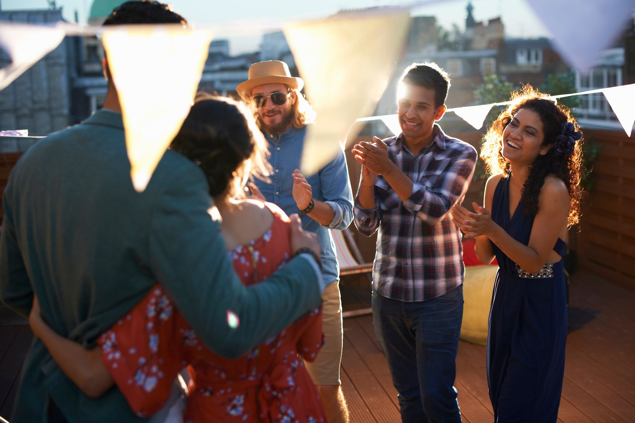 Group of friends celebrating couple who recently got engaged