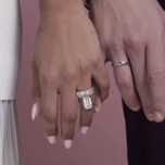 Couple holding hands, one of them wearing an engagement ring