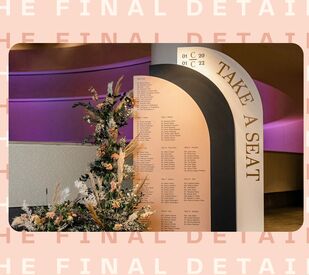 Large arch seating chart display with flower arrangement