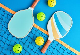 Two pickleball bats on a court